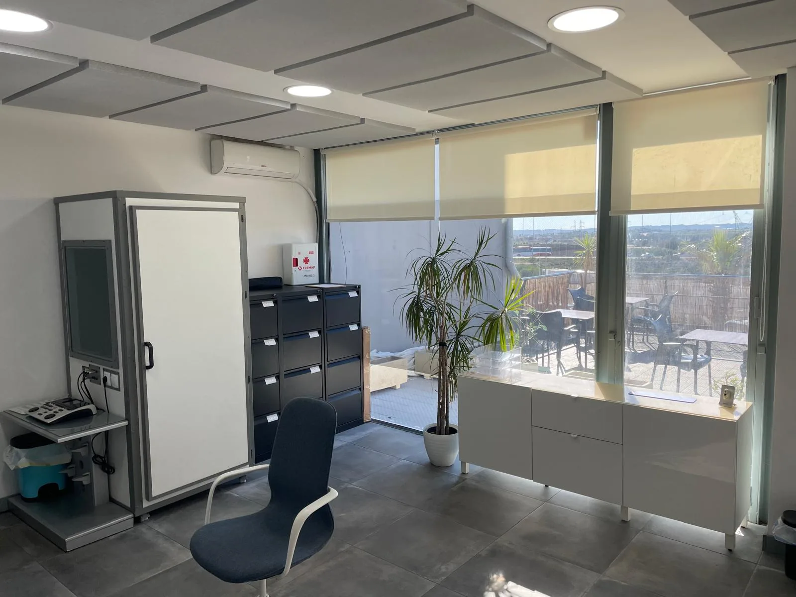 Inside our Ciudad Quesada clinic - audiometric testing booth, consultation chair and bright terrace views