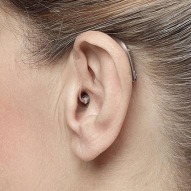 Receiver-in-canal (RIC) hearing aid worn behind the ear